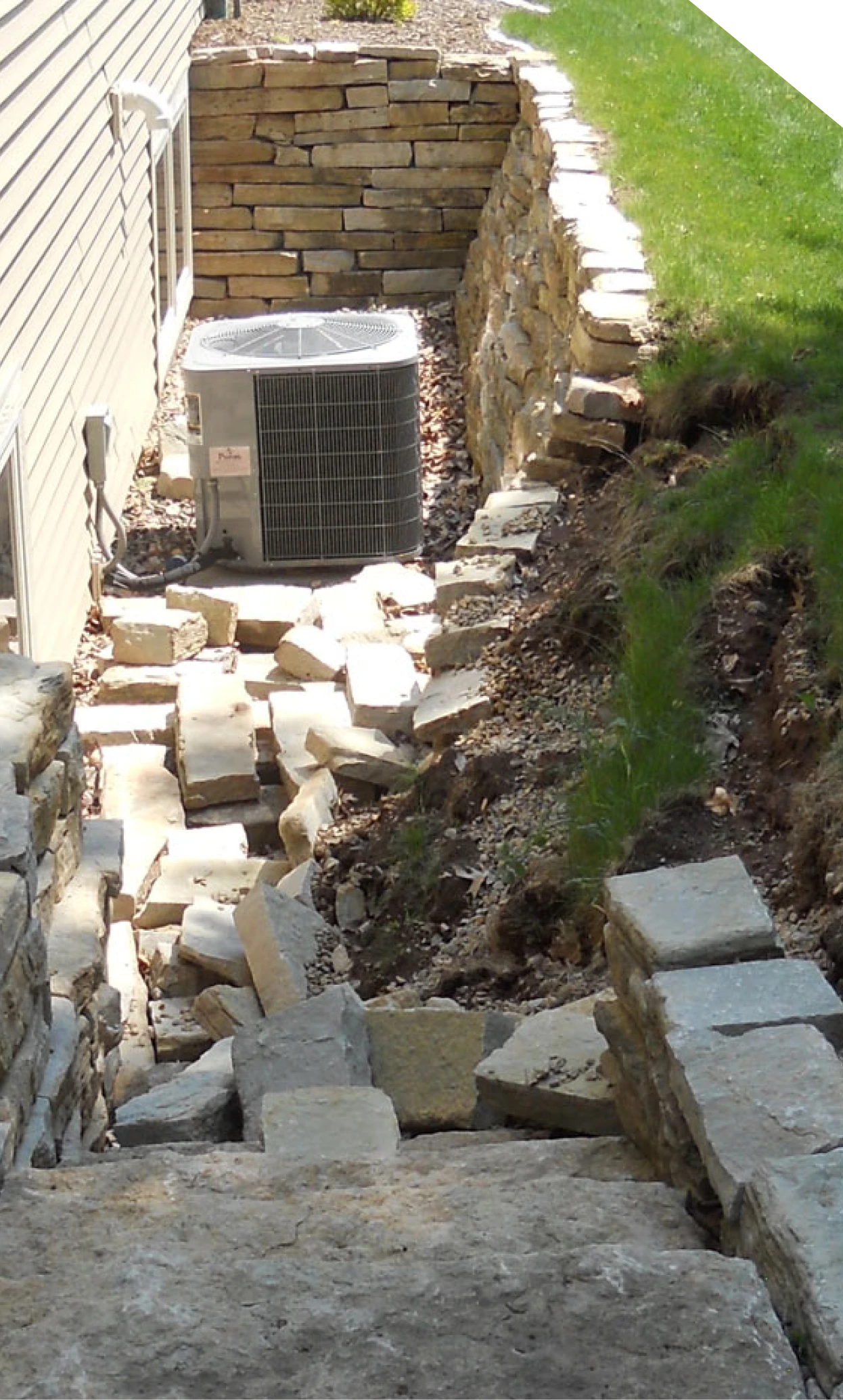 Collapsed stone retaining wall beside a home in Fort Mill, SC