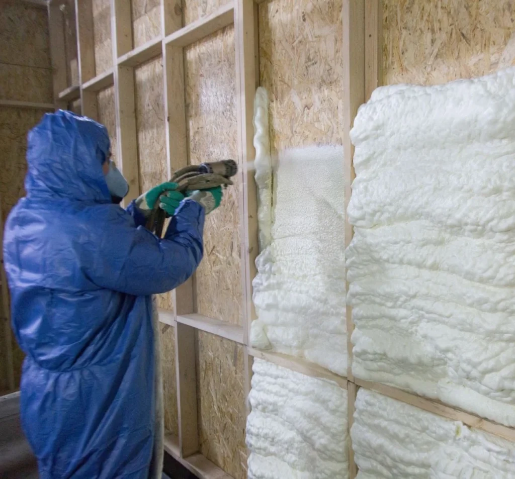 Technician applying polyurethane foam inside commercial wall framing in Fort Mill, SC.