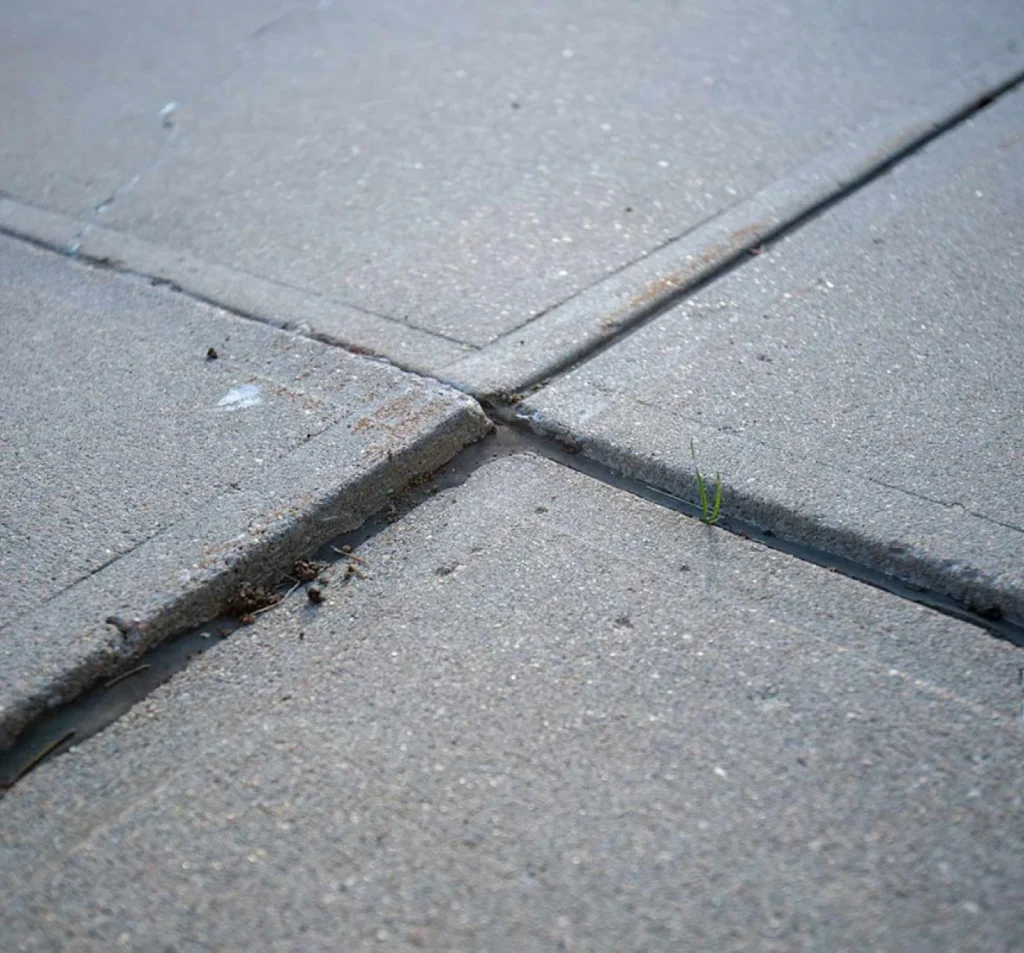 Uneven commercial concrete slabs creating raised edges and trip hazards before lifting and leveling in Fort Mill, SC.