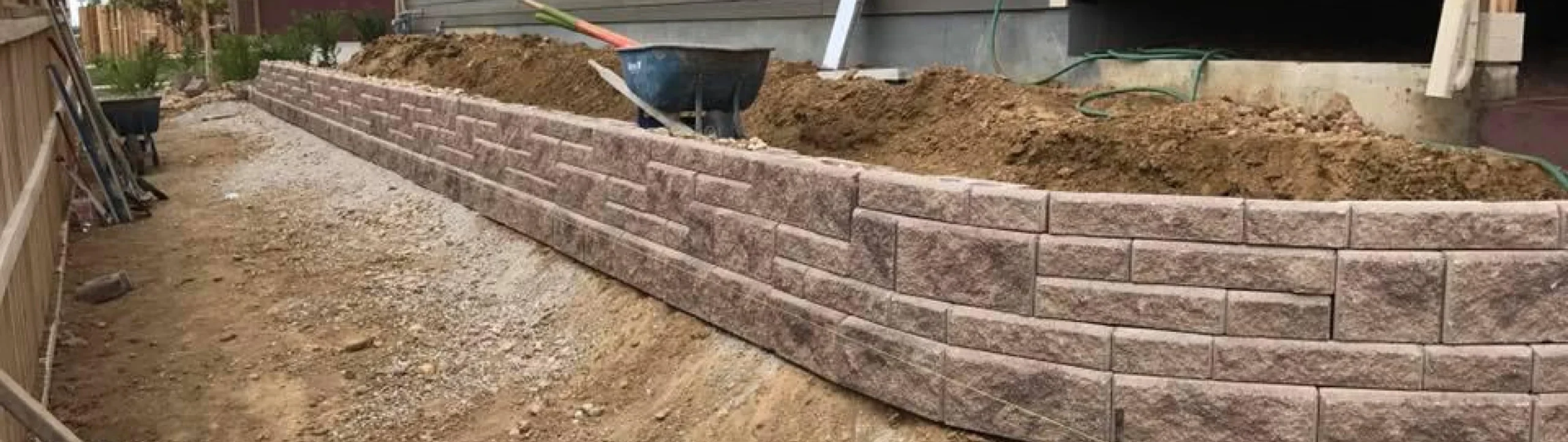 Rebuilt concrete block retaining wall beside a home in Fort Mill, SC