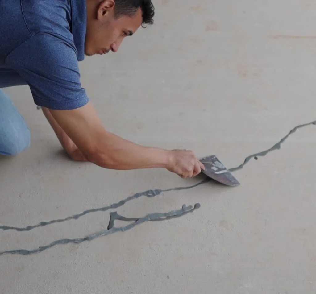Technician sealing a crack in a concrete slab in Fort Mill, SC