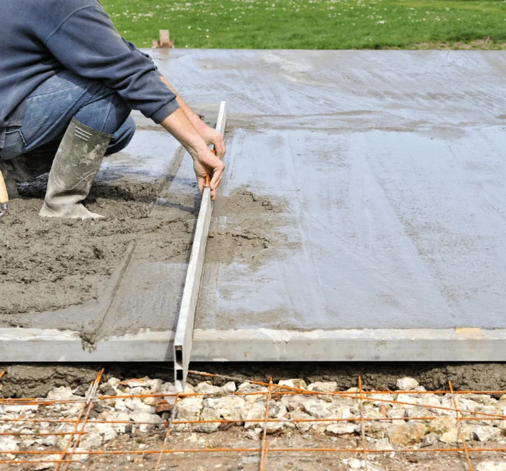 Worker leveling fresh concrete during slab repair in Fort Mill, SC