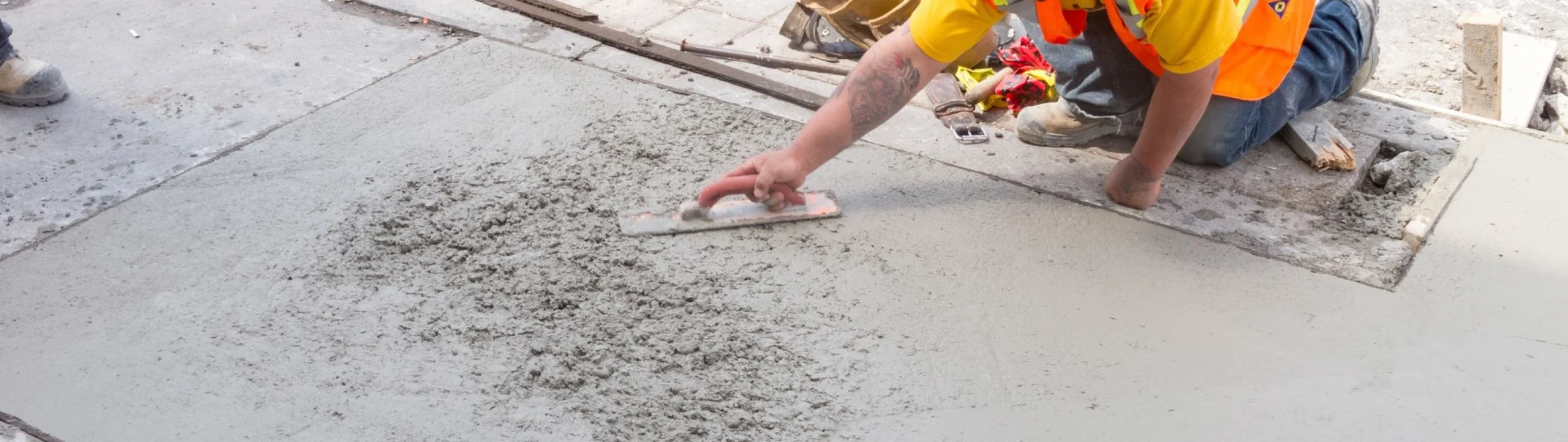 Worker smoothing fresh concrete during slab patch repair in Fort Mill, SC
