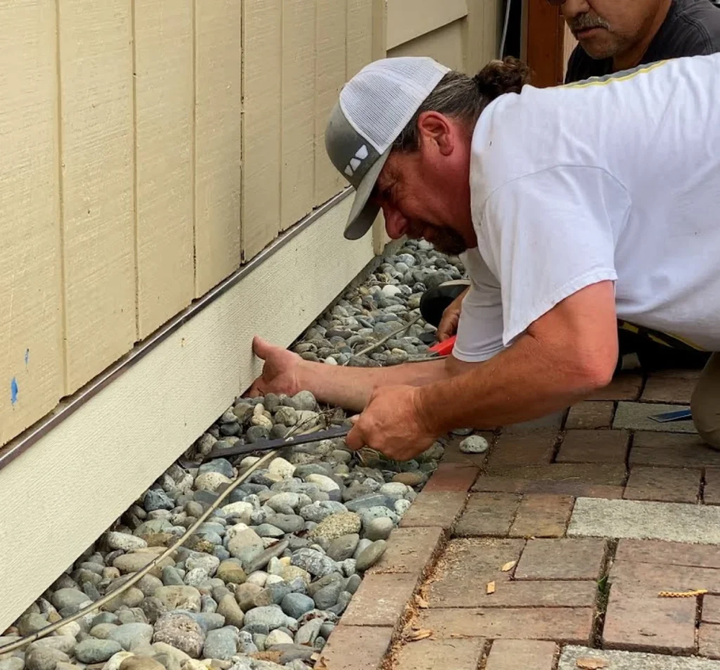 Technicians repairing crawl space access beneath a home in Fort Mill, NC
