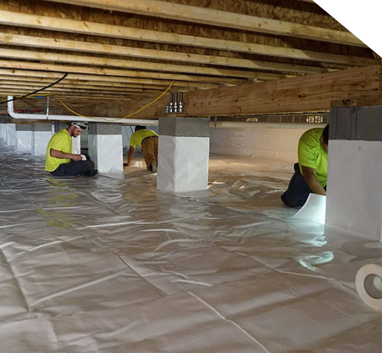 Technicians installing a crawl space vapor barrier in Fort Mill, SC
