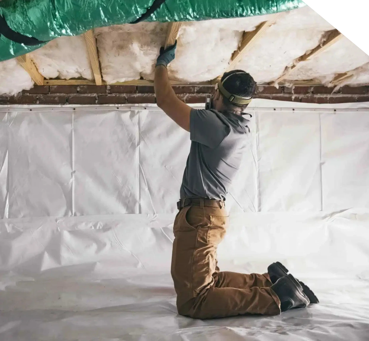 Technician inspecting crawl space insulation during repair in Fort Mill, NC