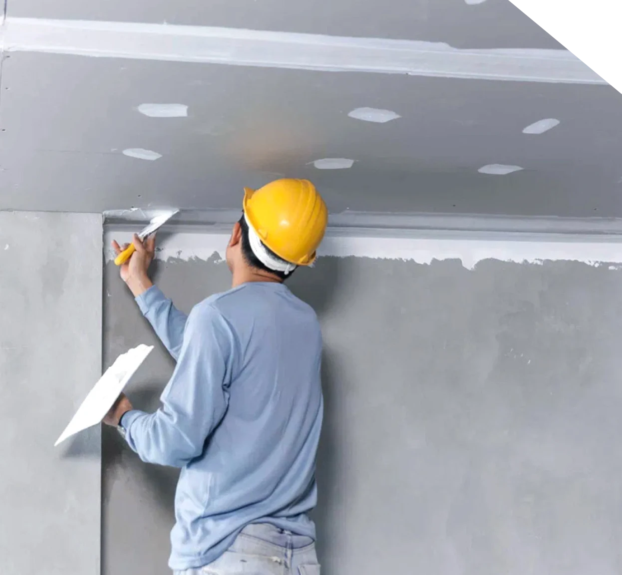 Worker finishing drywall after basement wall repair in Fort Mill, SC