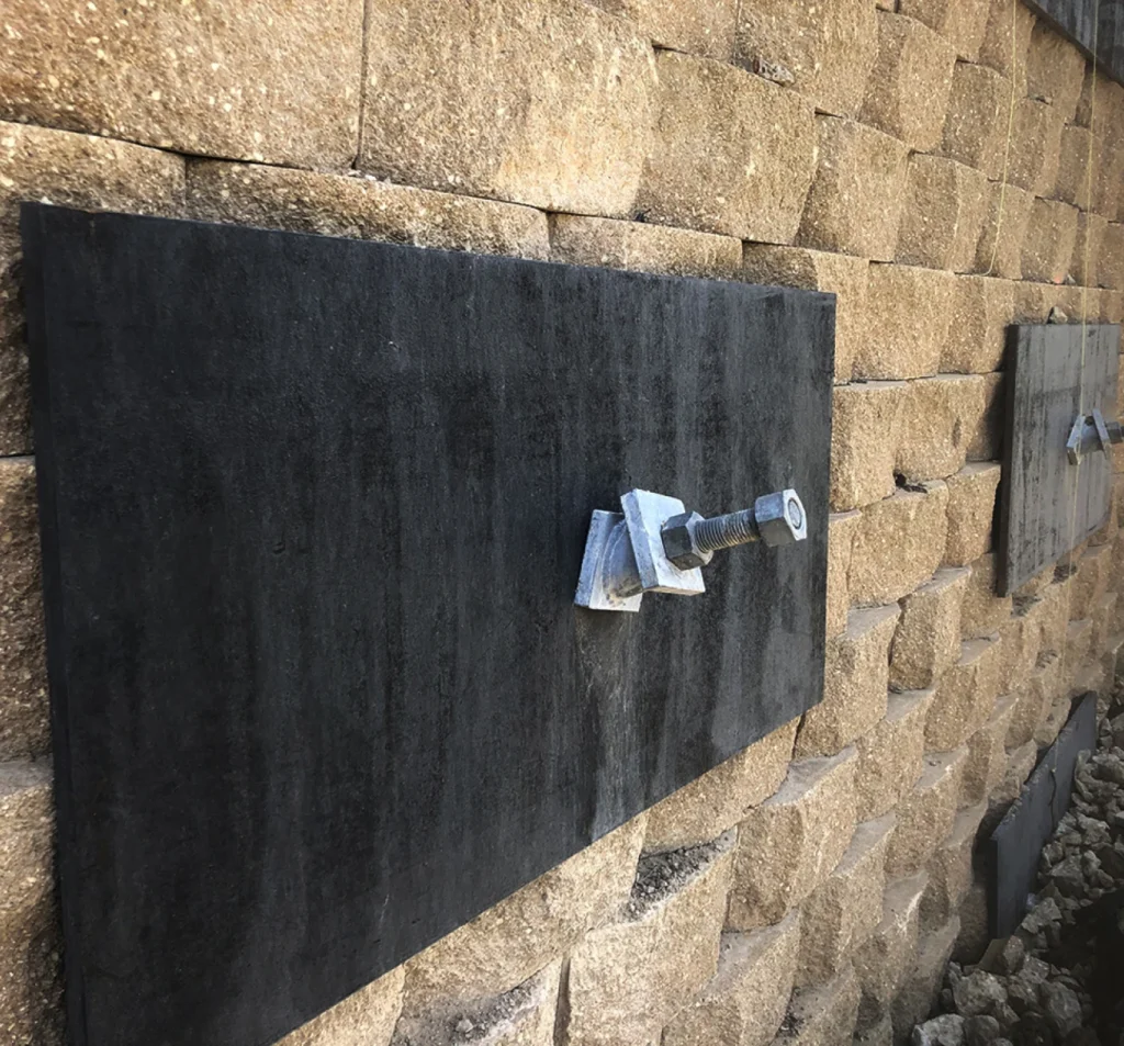 Exterior wall anchor plates stabilizing a block foundation wall in Fort Mill, NC