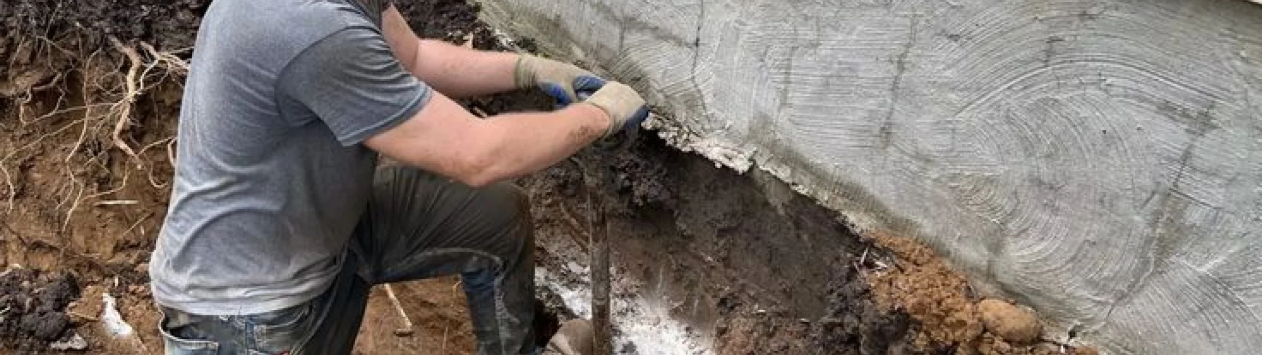 Worker repairing an exposed foundation wall in Fort Mill, SC