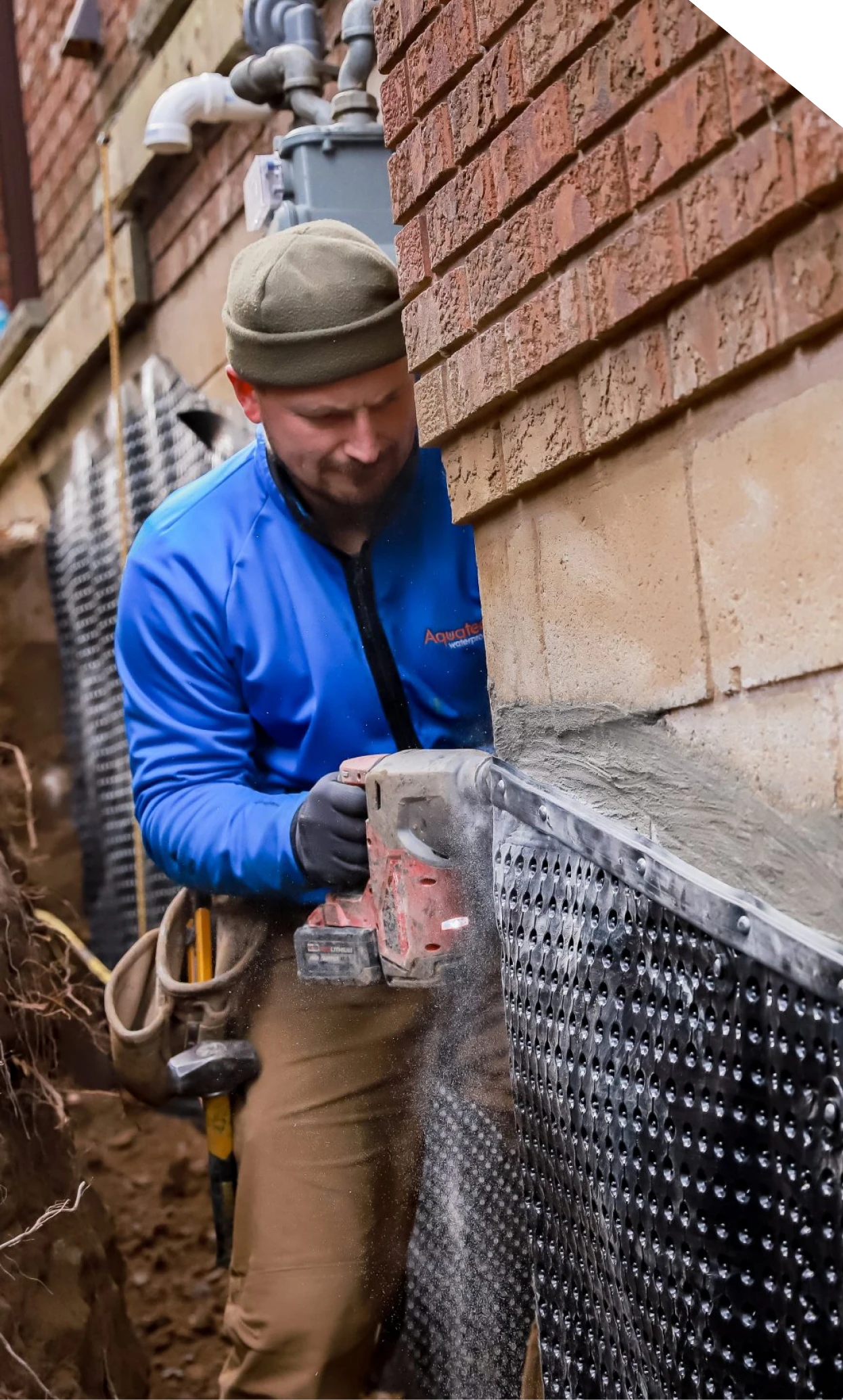 Technician installing waterproofing membrane on a foundation wall in Fort Mill, SC