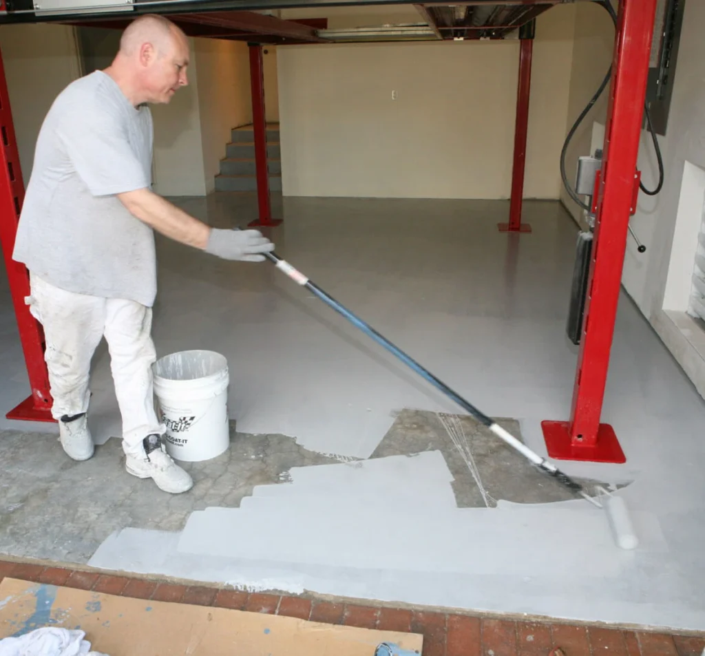Technician applying a smooth coating to a leveled garage concrete floor in Fort Mill, SC