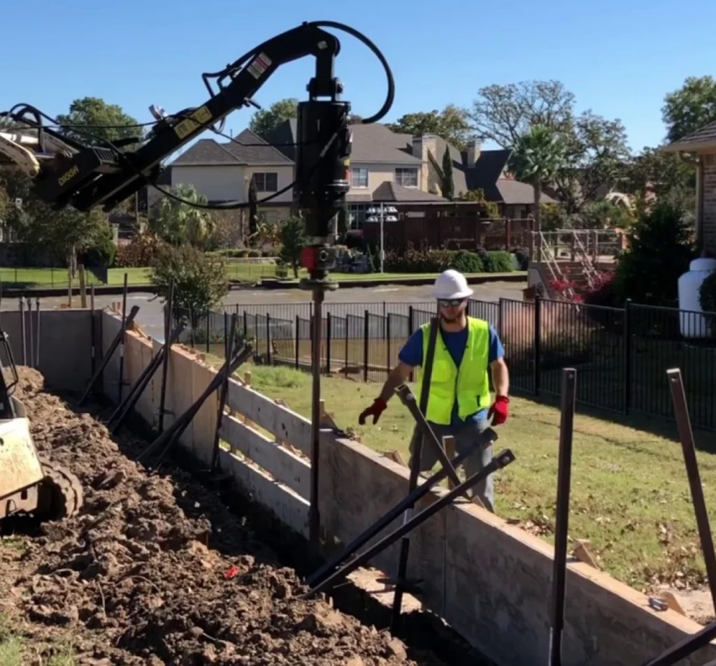 Technician installing a helical pier for foundation stabilization in Fort Mill, SC