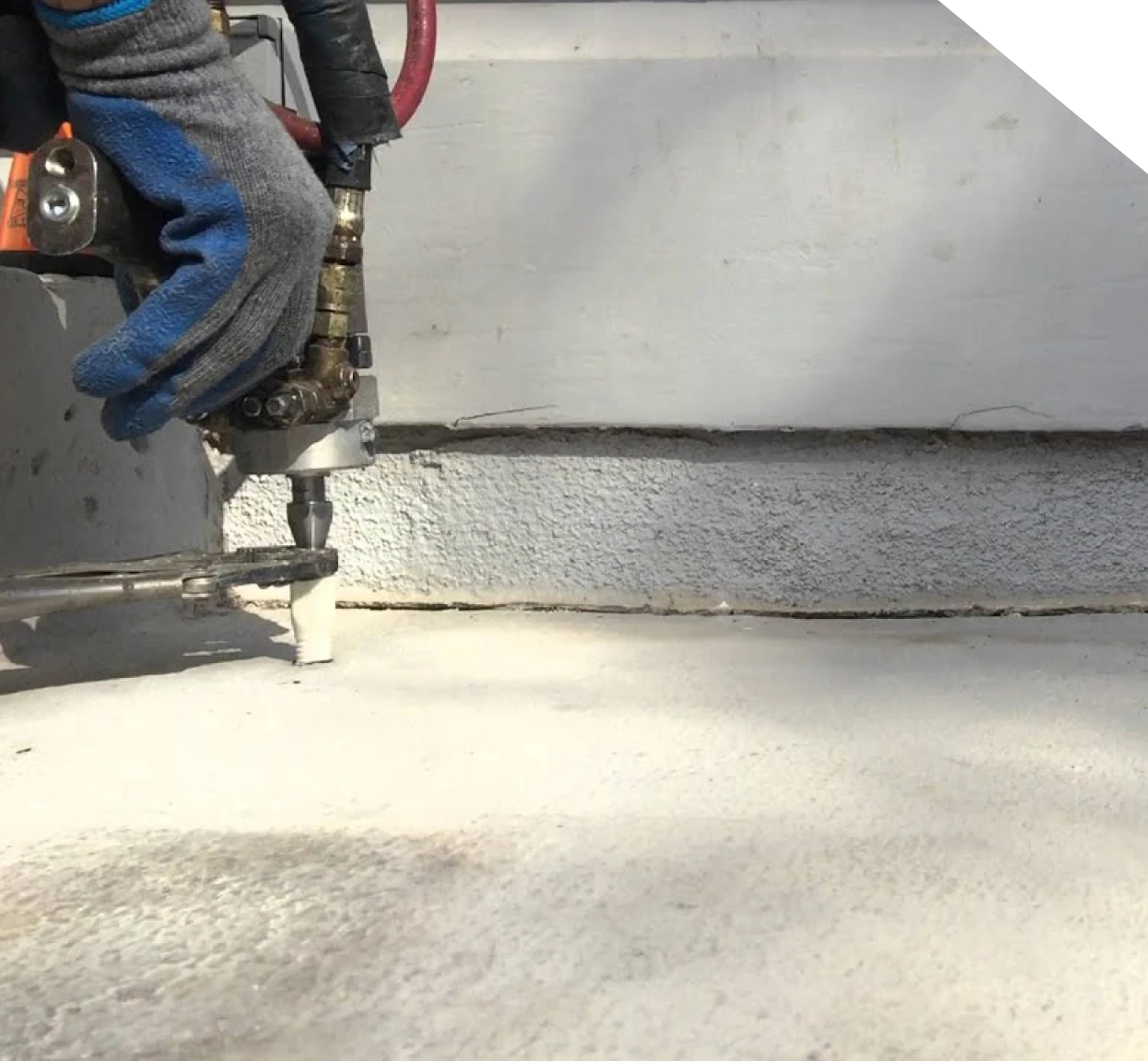 Technician injecting polyurethane foam beneath a concrete slab in Fort Mill, SC