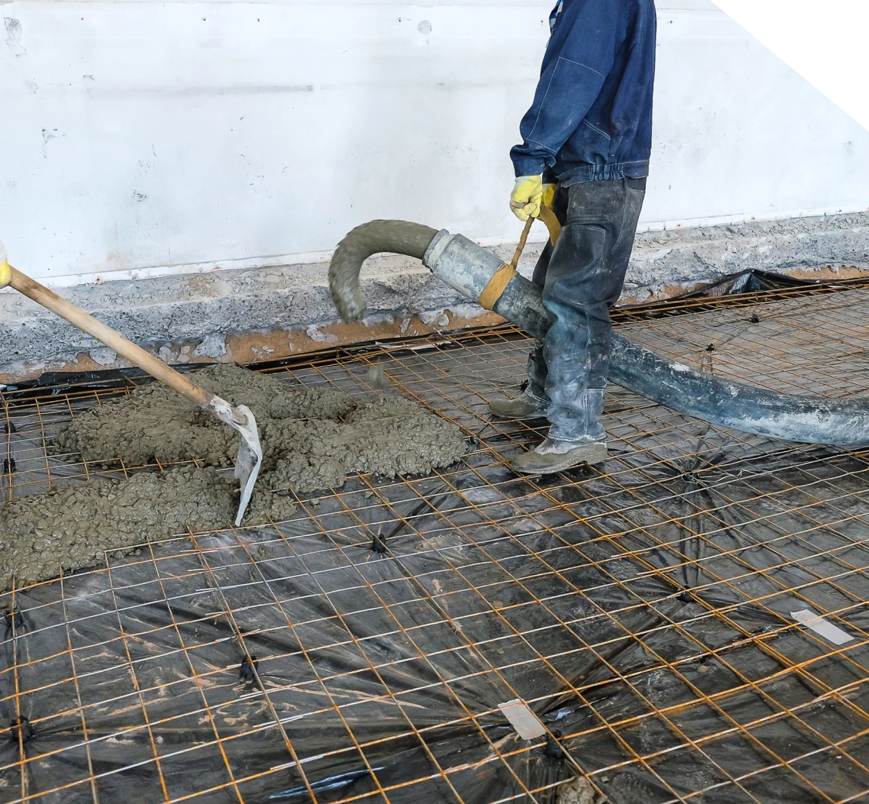 Workers pouring concrete over steel reinforcement for slab repair in Fort Mill, SC