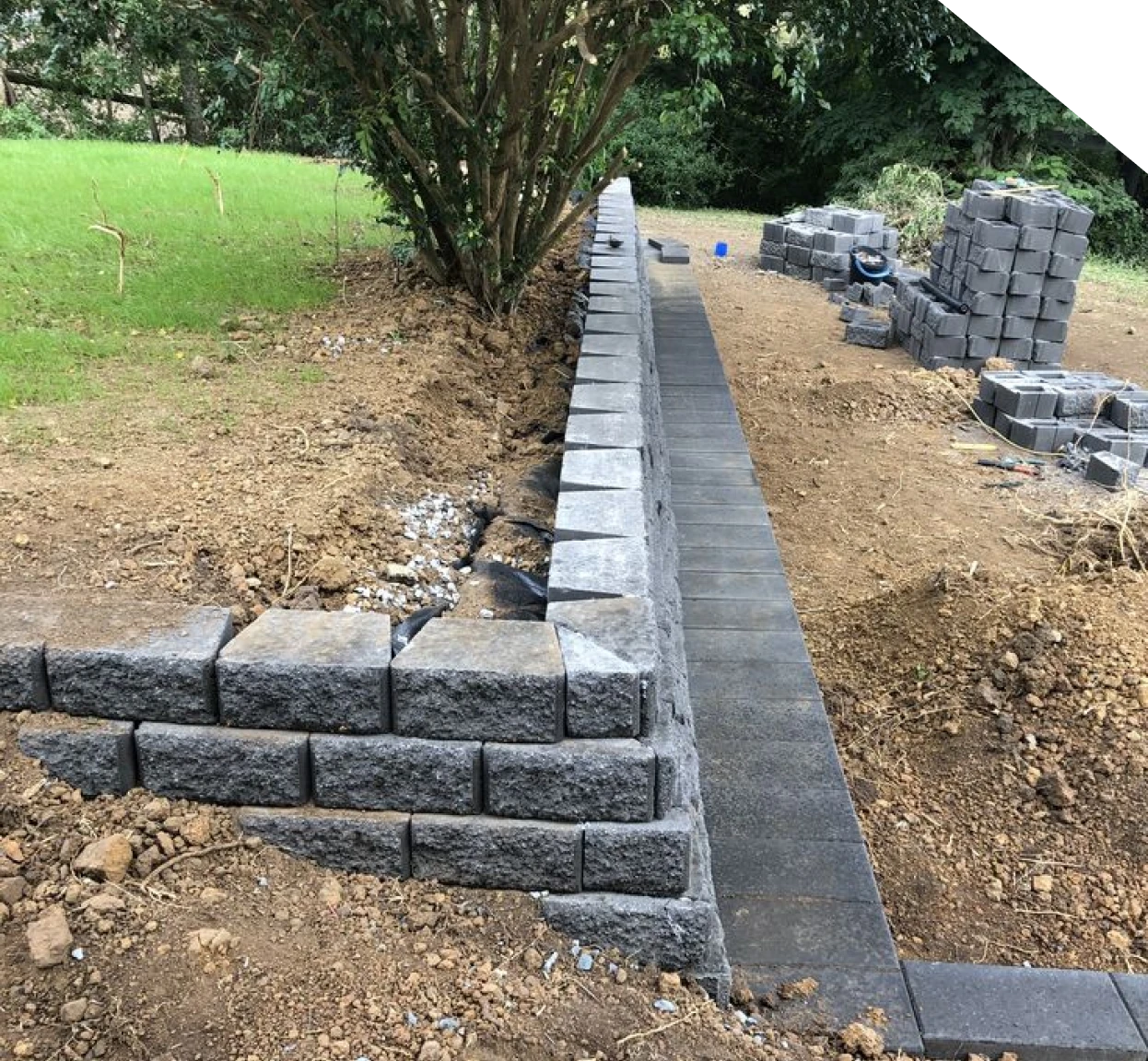 Technician inspecting cracks and movement in a retaining wall in Fort Mill, SC