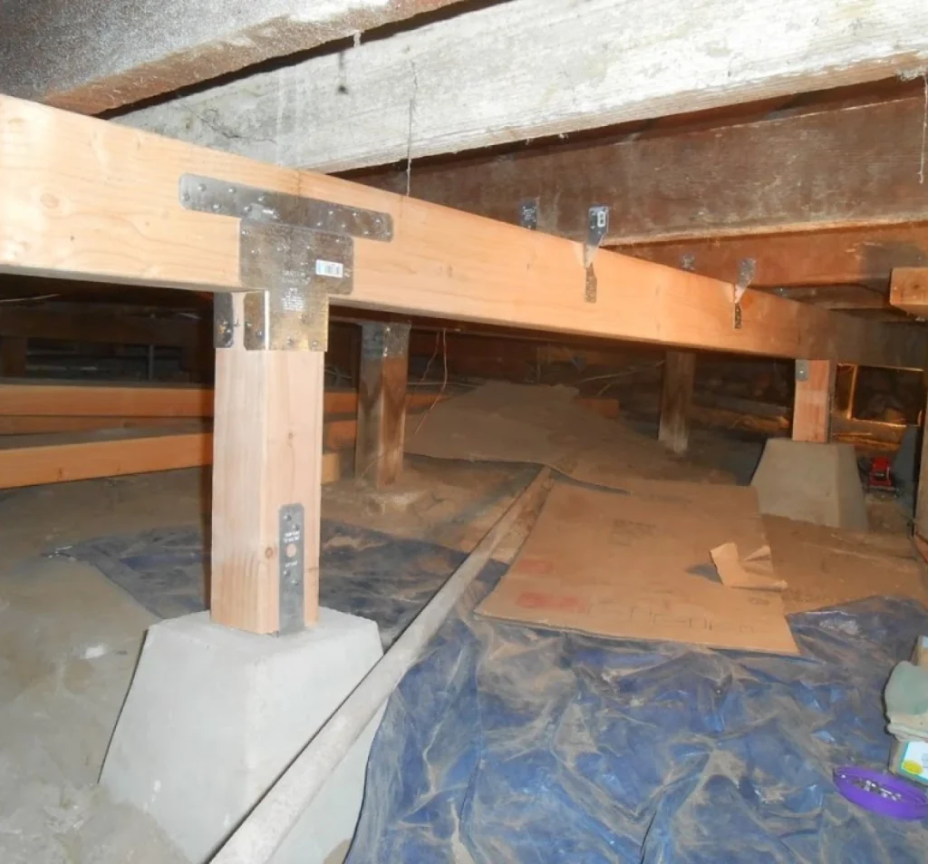 Structural supports being repaired beneath a sagging floor in Fort Mill, SC