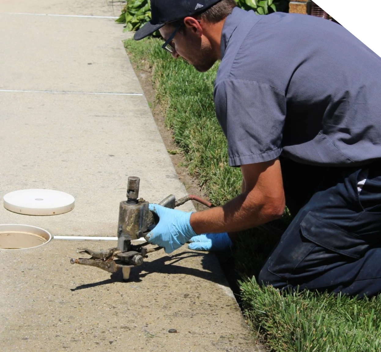 Technician injecting lifting foam beneath a concrete sidewalk in Fort Mill, SC