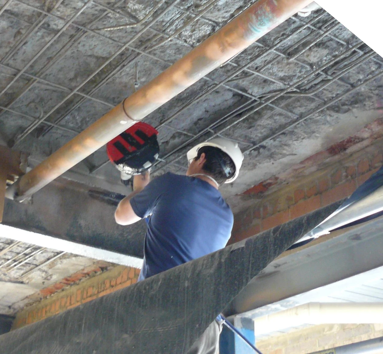 Specialist inspecting beams, floor framing, and structural supports beneath a home in Fort Mill, SC