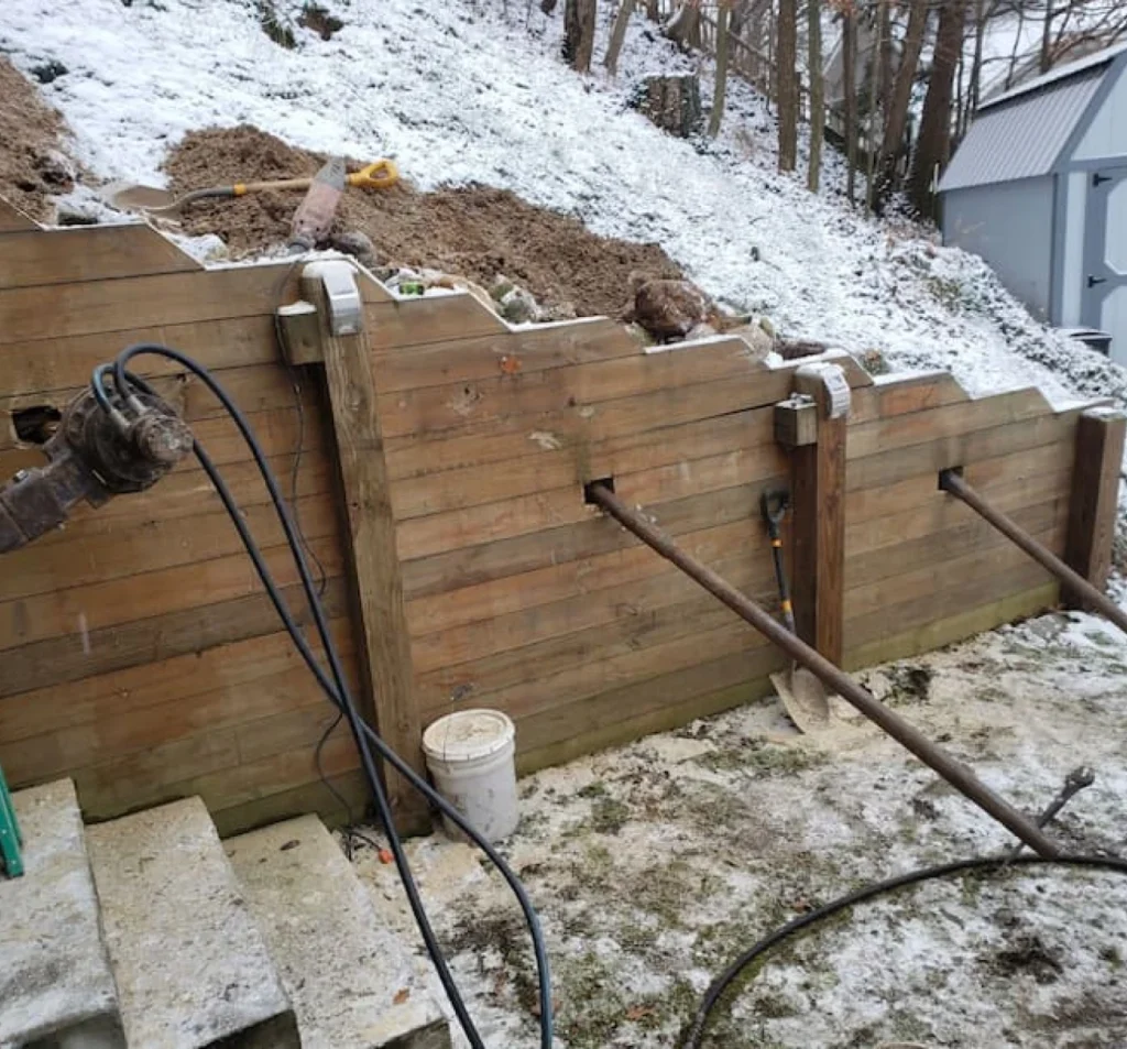 Anchors stabilizing a wood retaining wall in Fort Mill, SC